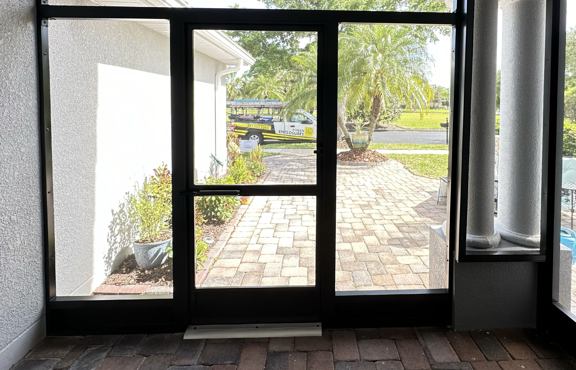 MD Construction truck outside a screened front entry way. Front lanai installation review. Screen enclosures. Screening a lanai. Screen enclosures near me. Sunrooms Orlando Florida. Poop Lanai. Sunroom Orlando fl. Lanai Patio enclosure. Patio enclosure suppliers. Patio cover with screen. Pool enclosure florida. patio cover screen. florida screened in porch. screen patio covers. pool screen enclosures florida. screen pool enclosures florida. patio screen enclosures near me. florida porches