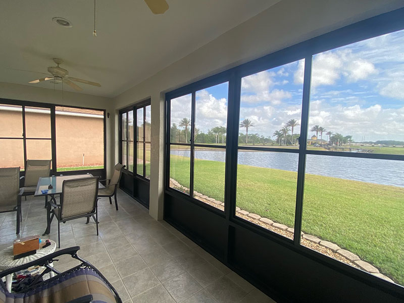 View from inside screen room looking out window.