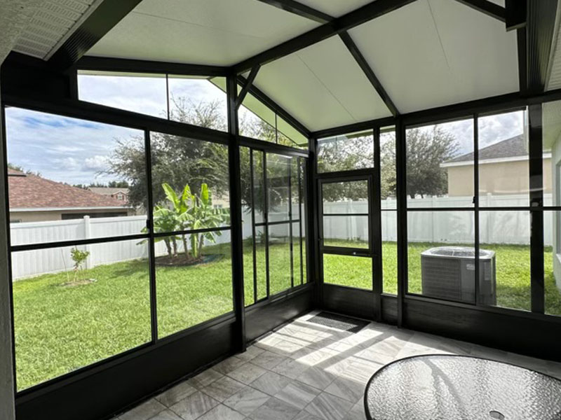 View from inside screen room looking out window.