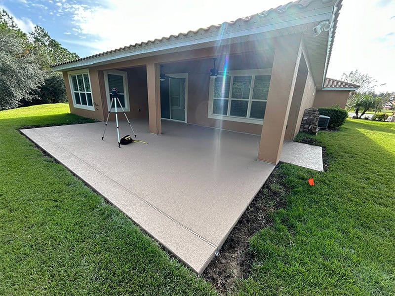Side view of new concrete slab installation for screen room install.