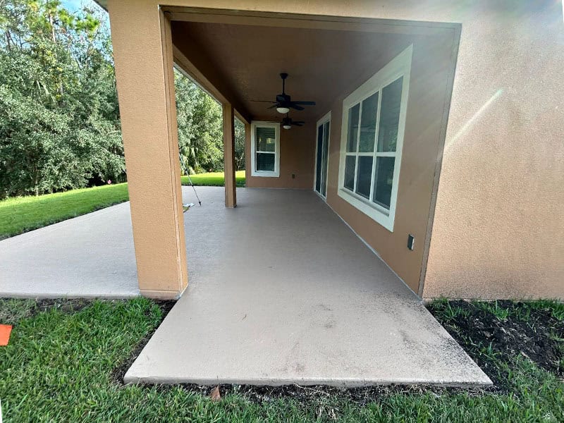 Side with door view of new concrete slab.