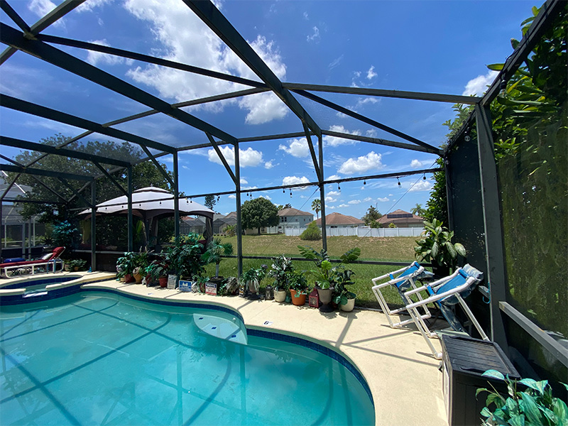 Inside view before pool enclosure screen extension showing gazebo outside of screen.