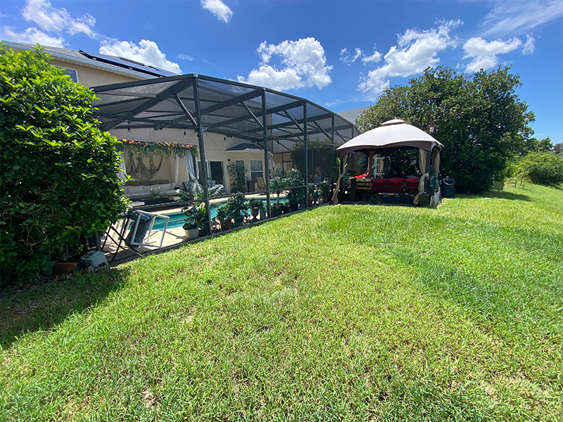 Pool enclosure before extension with gazebo outside of screen in Davenport, FL.