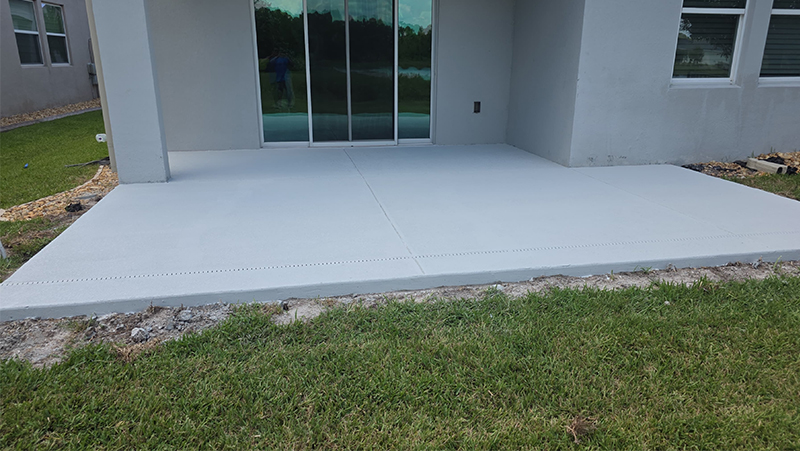 Concrete poured and cured for screen room installation in St. Cloud.