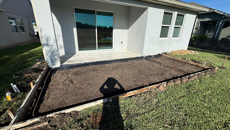 Concrete form setup for screen room installation in St. Cloud.