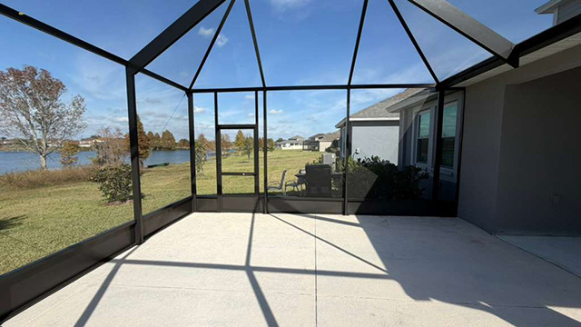 Photo taken by MD Construction workers of new screen enclosure installed off existing covered patio in Lakeland, Polk County Florida.