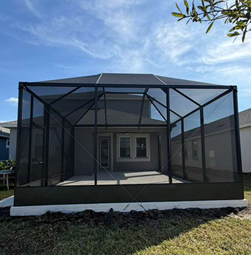 Photo taken by MD Construction workers of new screen enclosure installed off existing covered patio in Lakeland, Polk County Florida.