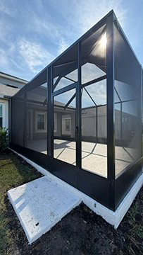 Photo taken by MD Construction workers of new screen enclosure installed off existing covered patio in Lakeland, Polk County Florida.