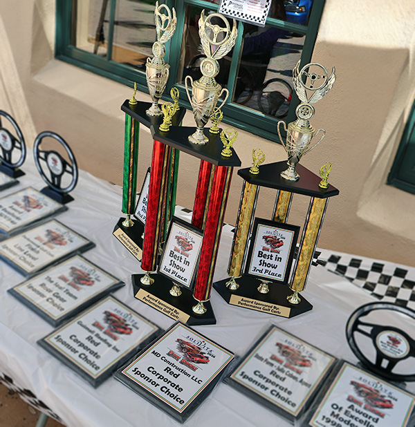 Solivita annual car show award tent with trophy and plaques. MD construction sponsoring this annual car show as a red corporate sponsor choice
