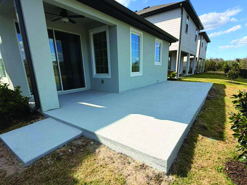 Concrete for patio expansion set ready for screen enclosure installation in Kissimmee, Florida by MD Construction.