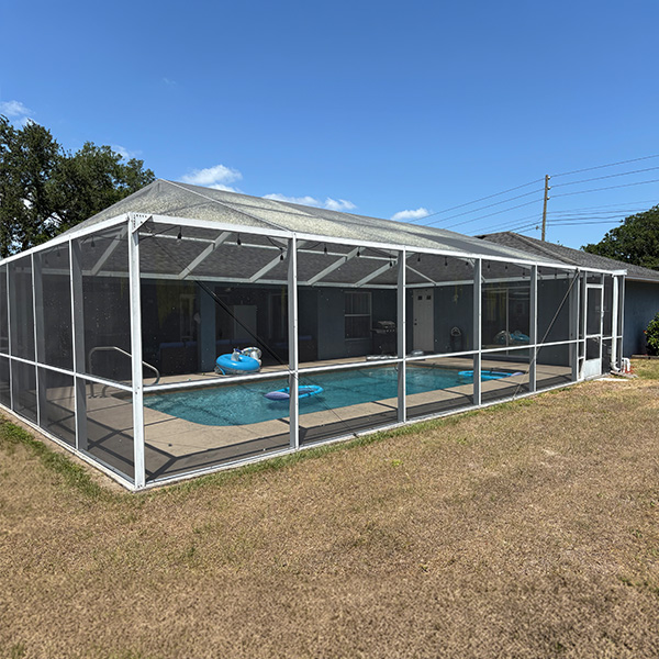 Outside view of the existing white aluminum pool enclosure that the client had since purchasing the house.
